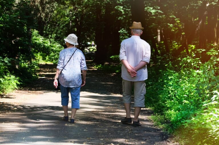 Elderly Couple Walking In A Park
