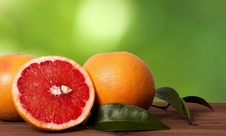Whole And Sliced Grapefruits