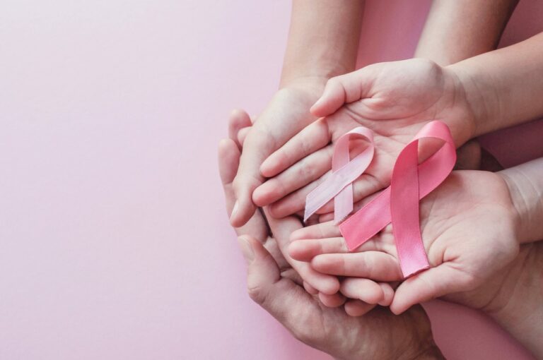 3 People's Hands Holding Breast Cancer Awareness Ribbons