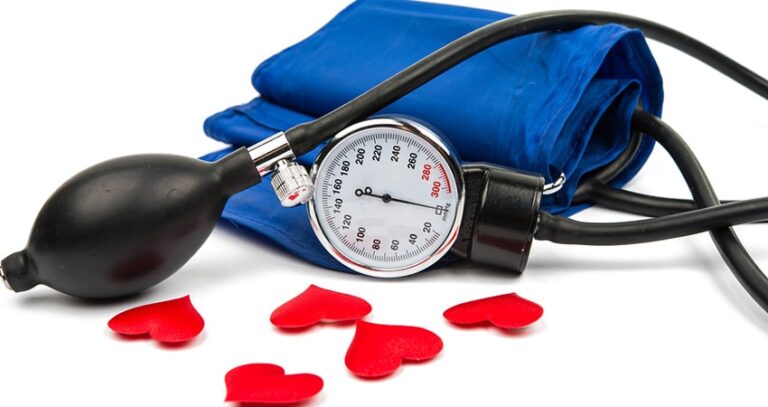 Blood Pressure Monitor Beside Red Paper Hearts