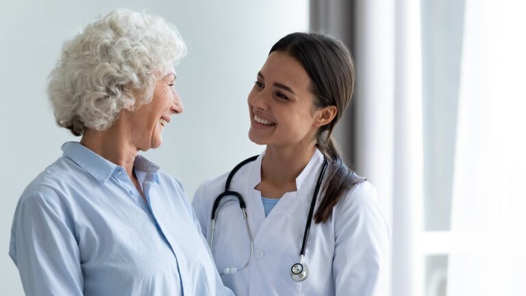 Older Woman And Young Nurse Sharing A Happy Moment