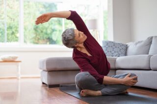 Older Woman Doing Yoga In Her Home