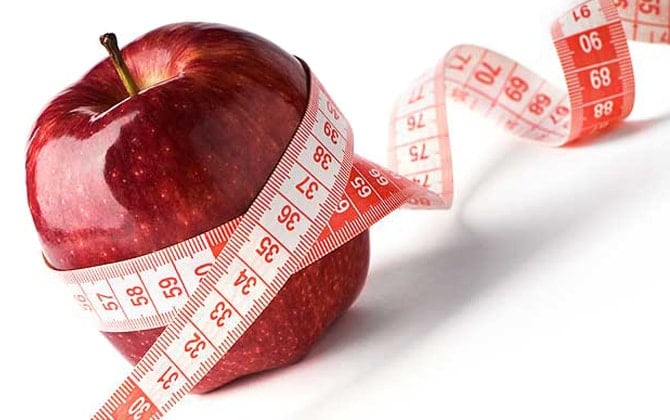 Red Apple With A Tape Measure Around It
